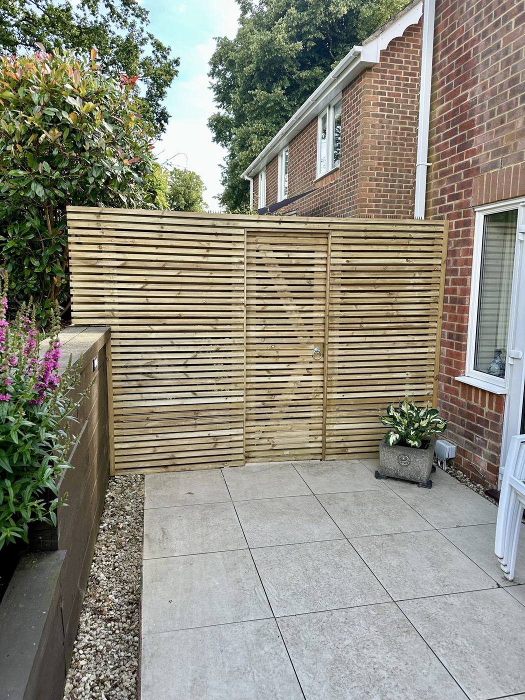 Horizontal slatted screen by a patio